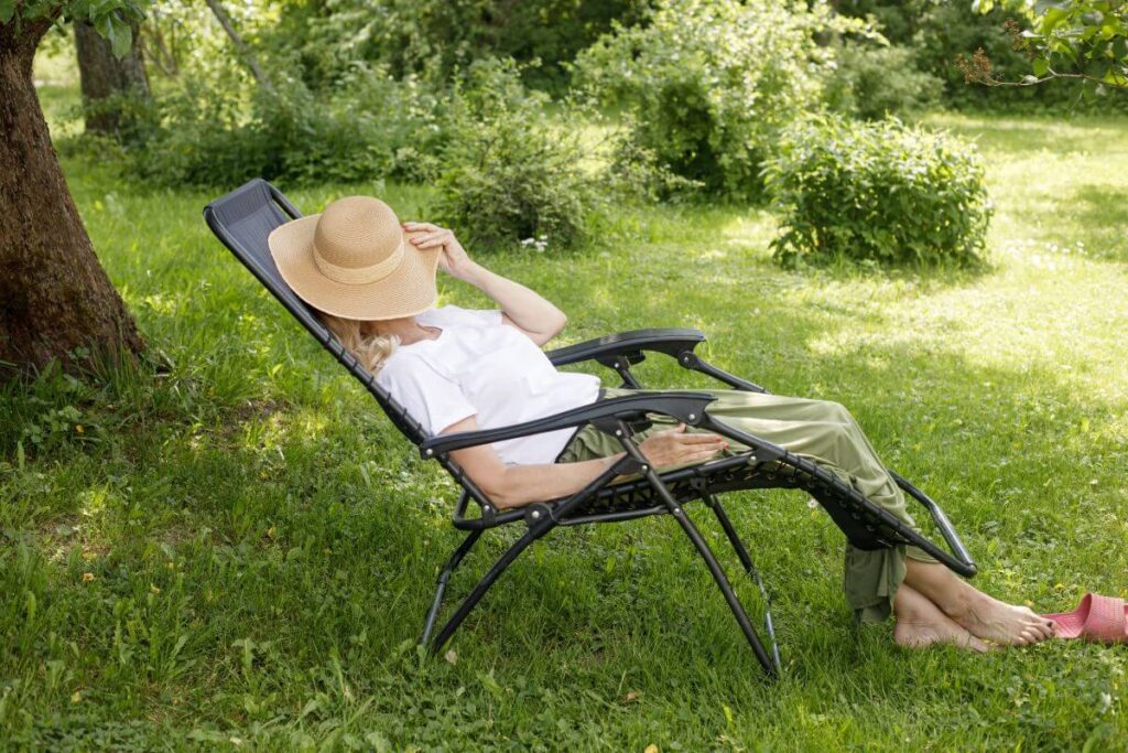 Image of a woman lounging in a zero gravity chair that could potentially be defective.