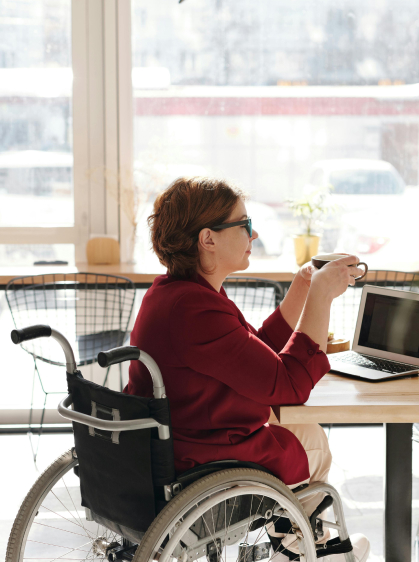 person in wheelchair sitting up to a table